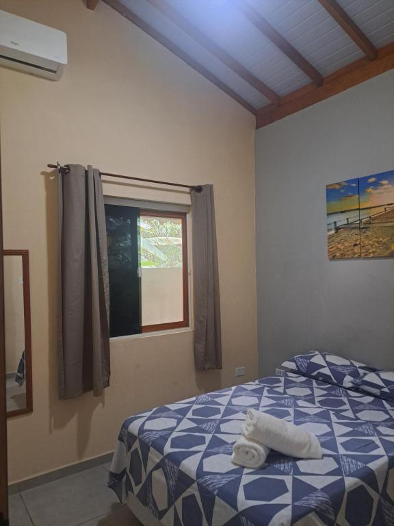 a bedroom with a bed with towels on it at Casa do Mar & Ane Ilhabela in Ilhabela