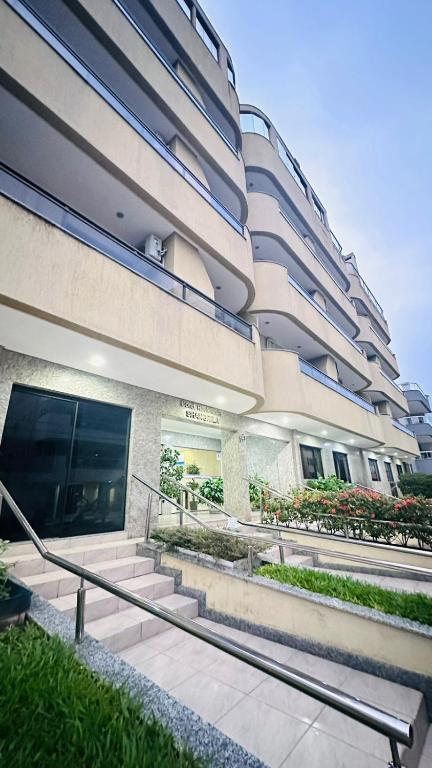 a building with stairs in front of a building at Apartamento 100metros do Mar 2 quartos in Bombinhas
