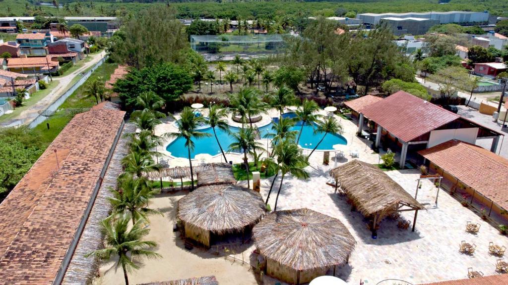 an aerial view of a resort with two pools and umbrellas at Arena Carneiros Hotel by AFT in Tamandaré