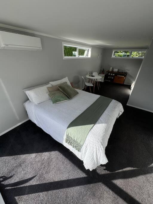 a bedroom with a large bed in a room at The Avenues Hideaway in Tauranga