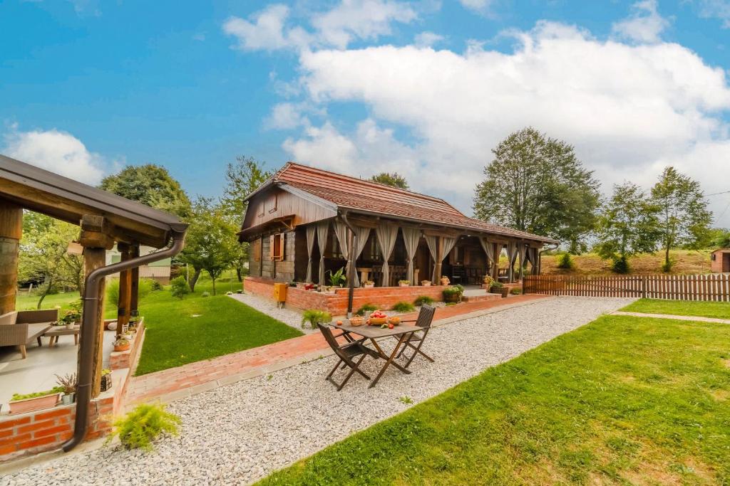 a pavilion with a table and chairs in a garden at Eco House Lina With Hot Tub and Sauna - Happy Rentals in Lopatinec