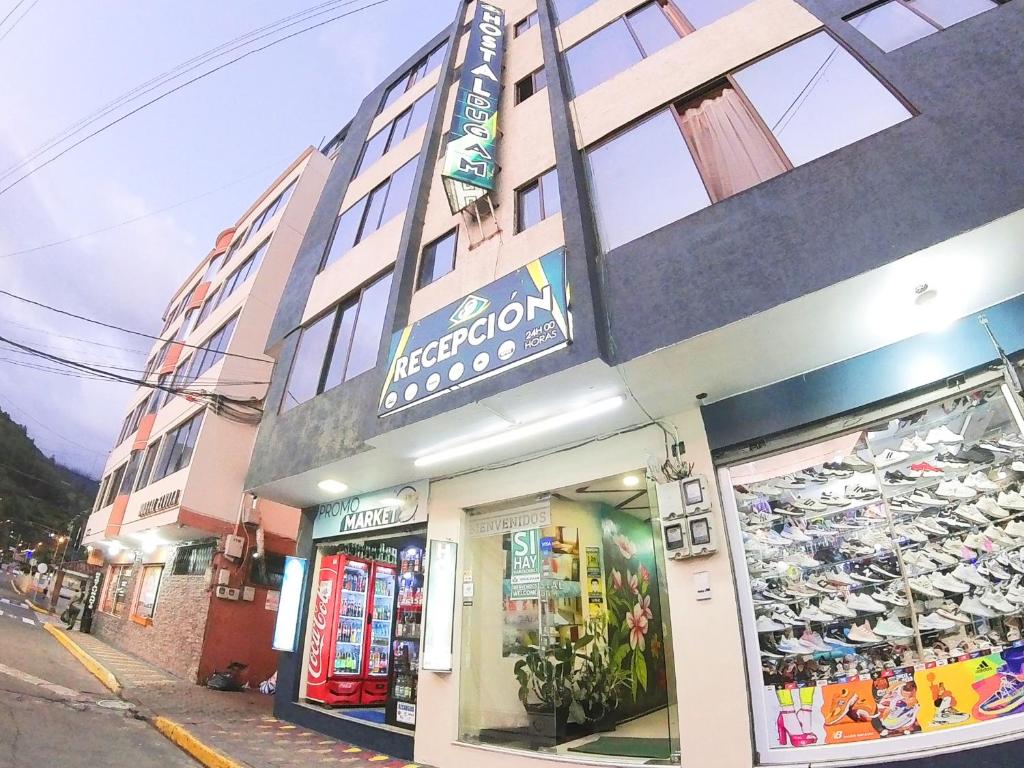 a store front of a building on a street at Hostal Dugan in Baños
