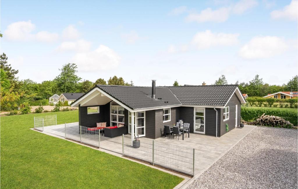 a modular home with a patio and grass at Nice Home In Tarm With Sauna in Tarm