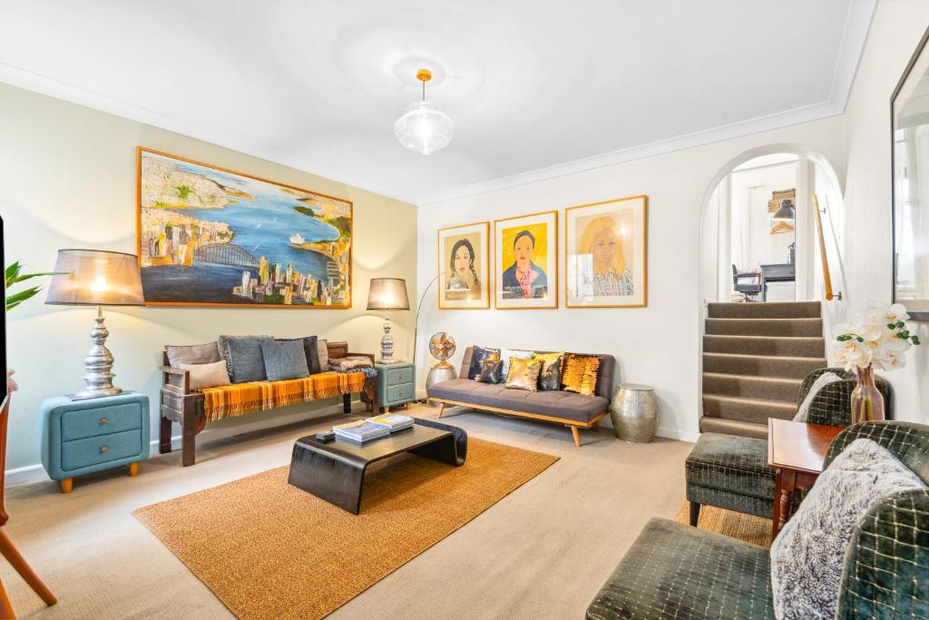 a living room with a couch and a table at 'Enmore Lane' A Central Eclectic Artist Escape in Sydney