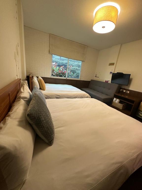 Postel nebo postele na pokoji v ubytování Siangting B&B