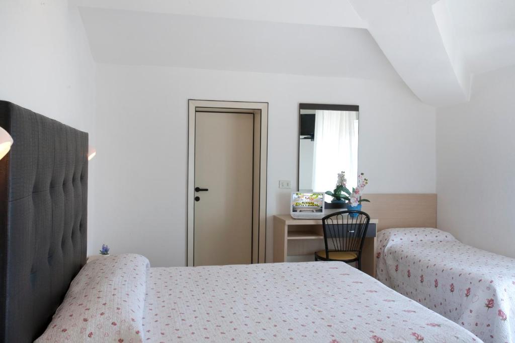 Postel nebo postele na pokoji v ubytování Hotel Universal