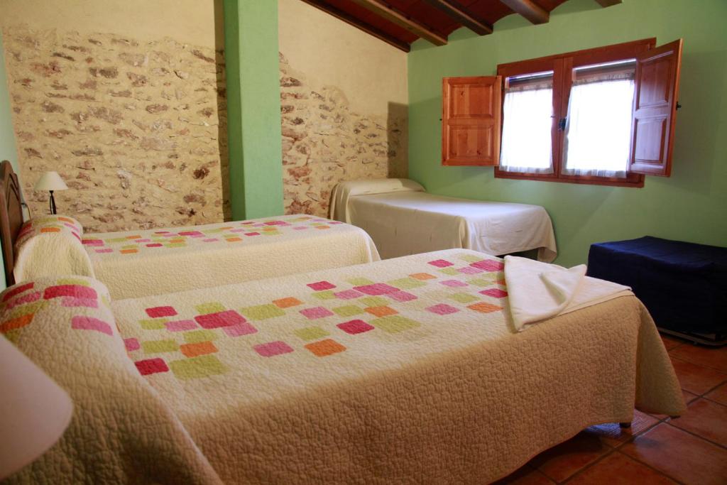 A bed or beds in a room at Casas Rurales Tío Segundo