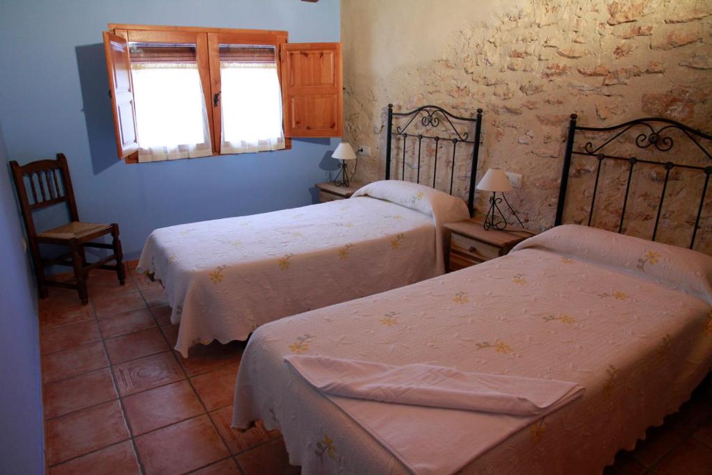 A bed or beds in a room at Casas Rurales Tío Segundo