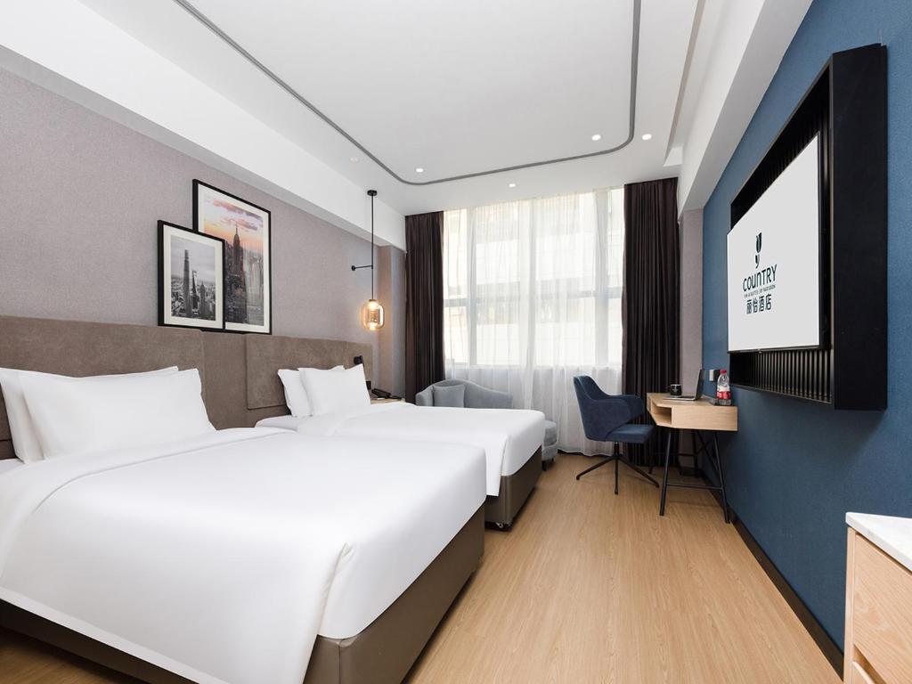 Postel nebo postele na pokoji v ubytování Country Inn & Suites by Radisson Shenzhen International Convention and Exhibition Center