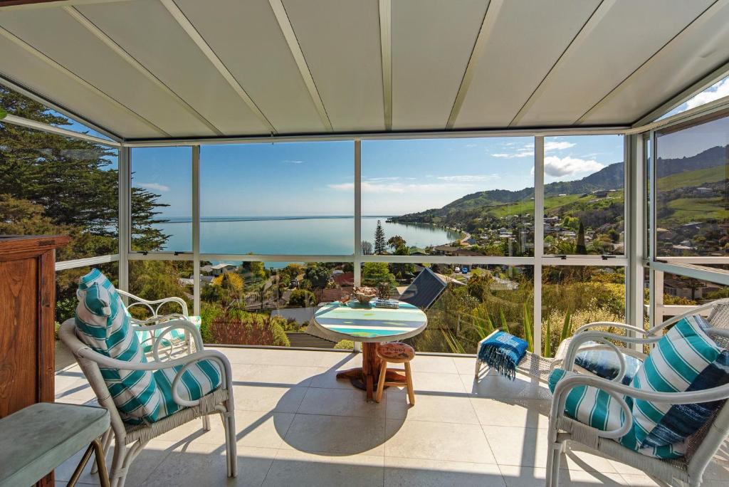 a balcony with a view of the ocean and mountains at Sea Tide Views - Atawhai in Nelson
