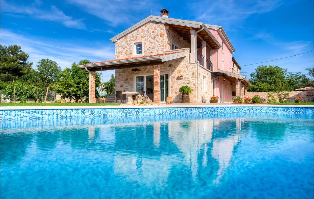 a house with a swimming pool in front of it at Villa Lemaliante in Umag