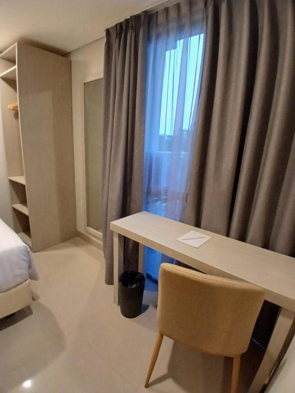 Postel nebo postele na pokoji v ubytování Nemuru Grand Suites