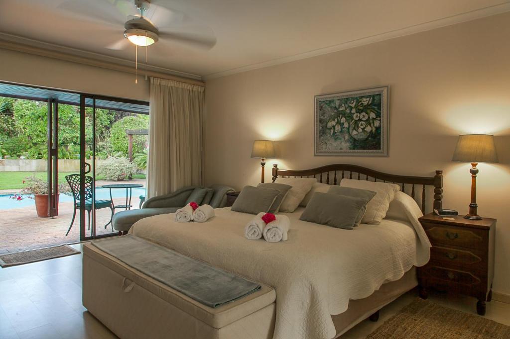 a bedroom with a bed with two towels on it at Majorca House in Somerset West