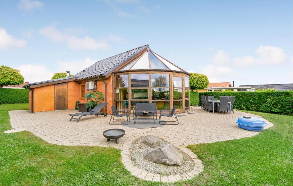 a house with a large gazebo in a yard at Two-Bedroom Holiday Home In Hejls in Hejls