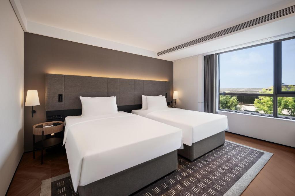 Postel nebo postele na pokoji v ubytování Intercity Hotel Chengdu High-tech Global Center
