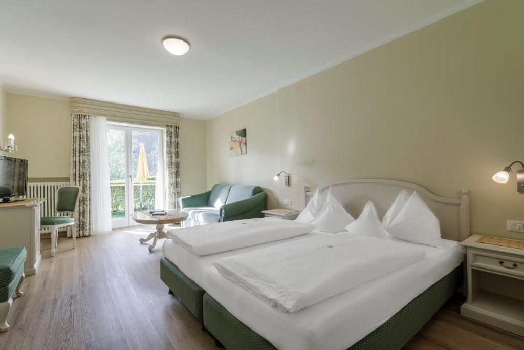 Postel nebo postele na pokoji v ubytování Hotel Mitlechnerhof