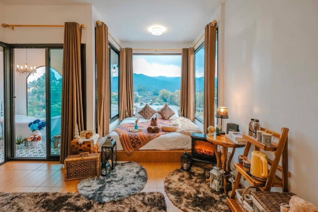 a bedroom with a bed with a large window at Ping fai camp inthanon in Chiang Mai