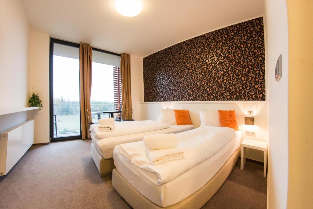 Postel nebo postele na pokoji v ubytování K-Triumf Resort