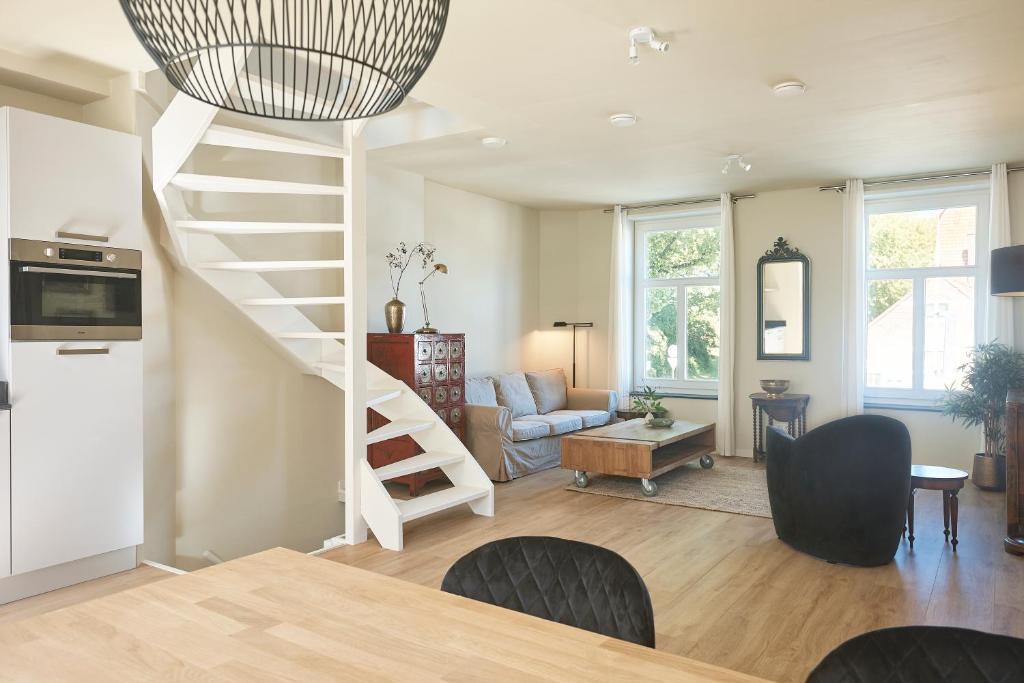 een woonkamer met een wenteltrap in een huis bij Apartment Bolwerkzicht in Middelburg