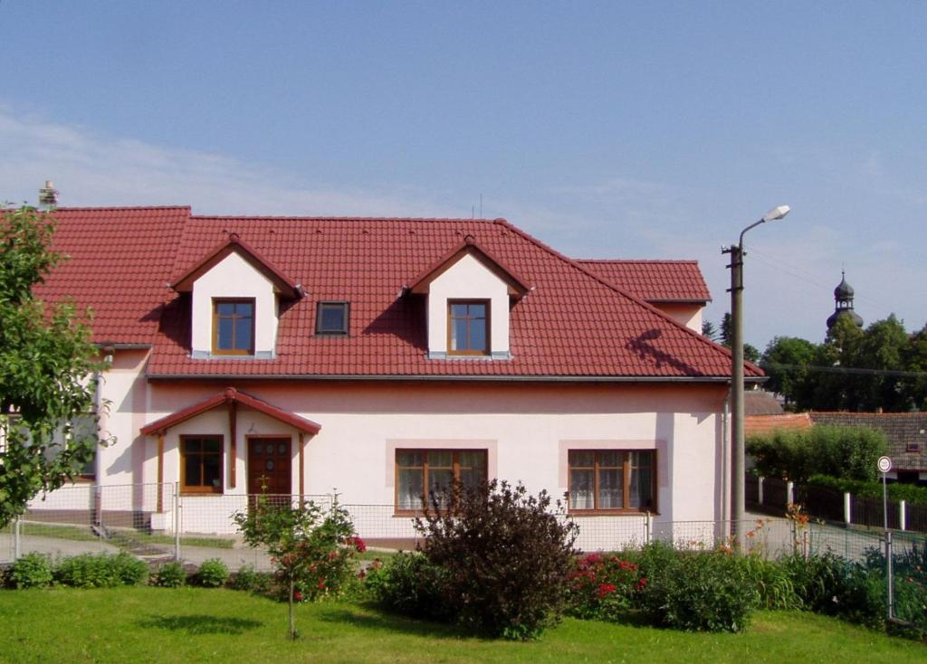 a house with a red roof at Apartments Ubytování U Zemanů in Chrášťany