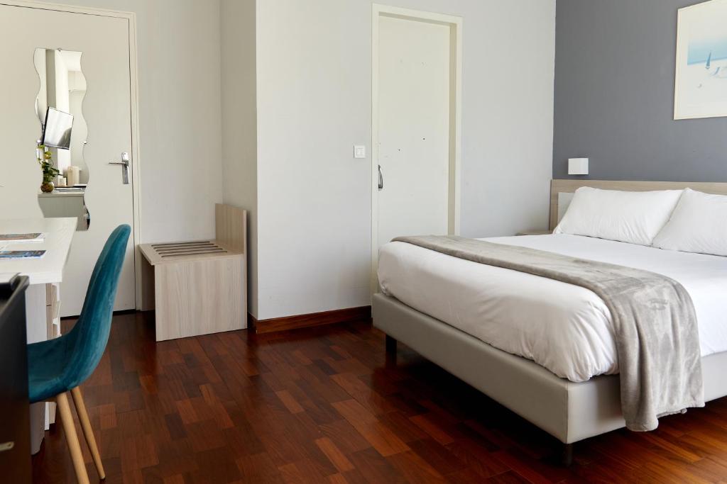 Postel nebo postele na pokoji v ubytování Hôtel Alexandra