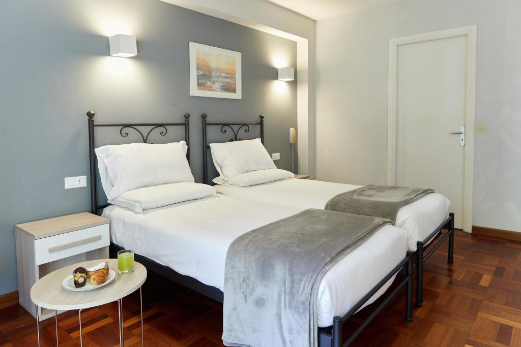 Postel nebo postele na pokoji v ubytování Hôtel Alexandra