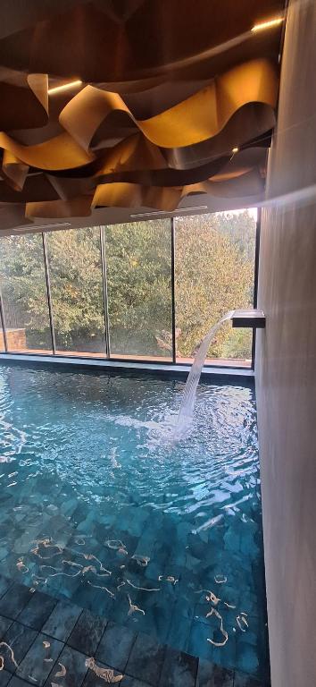 a pool with a water fountain in a building at Rio Moment's in Castelo de Paiva