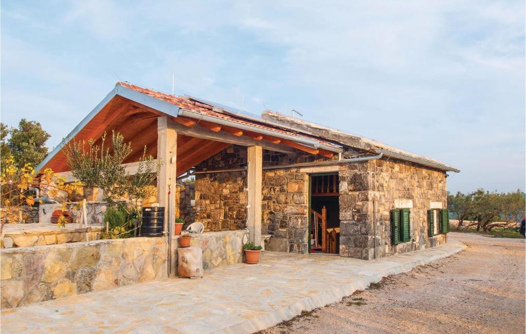 a small stone building with a stone wall at Holiday Home Jezera With A Fireplace 04 in Jezera