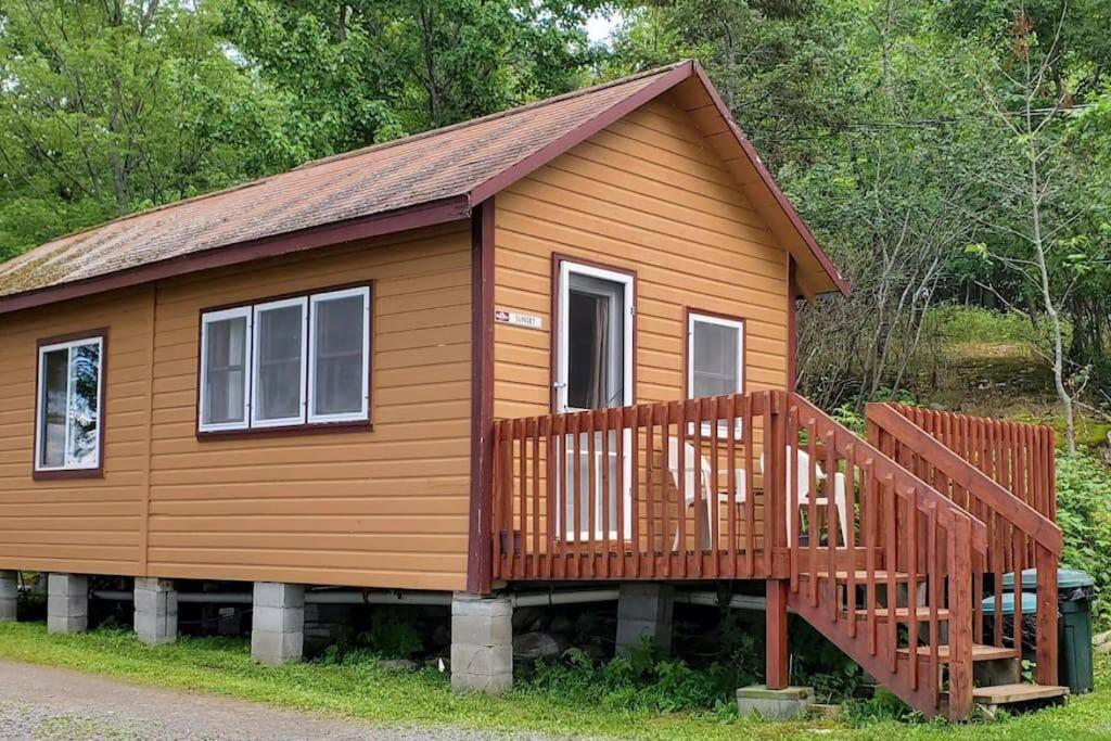 a large wooden cabin with a large deck at Marina View 1 Bedroom Sunset Cabin in Kabetogama