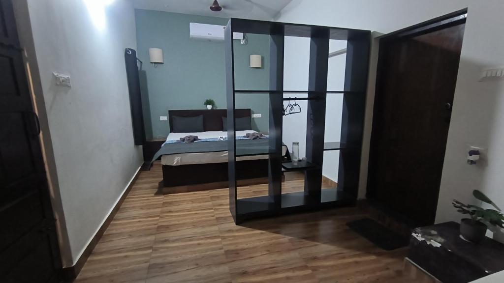 a bedroom with a mirror and a bed in a room at Mad about Coco Yoga & Beach Retreat in Varkala