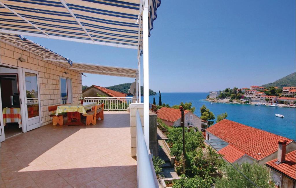 a balcony of a house with a view of the water at 4 Bedroom Beautiful Apartment In Brna in Brna
