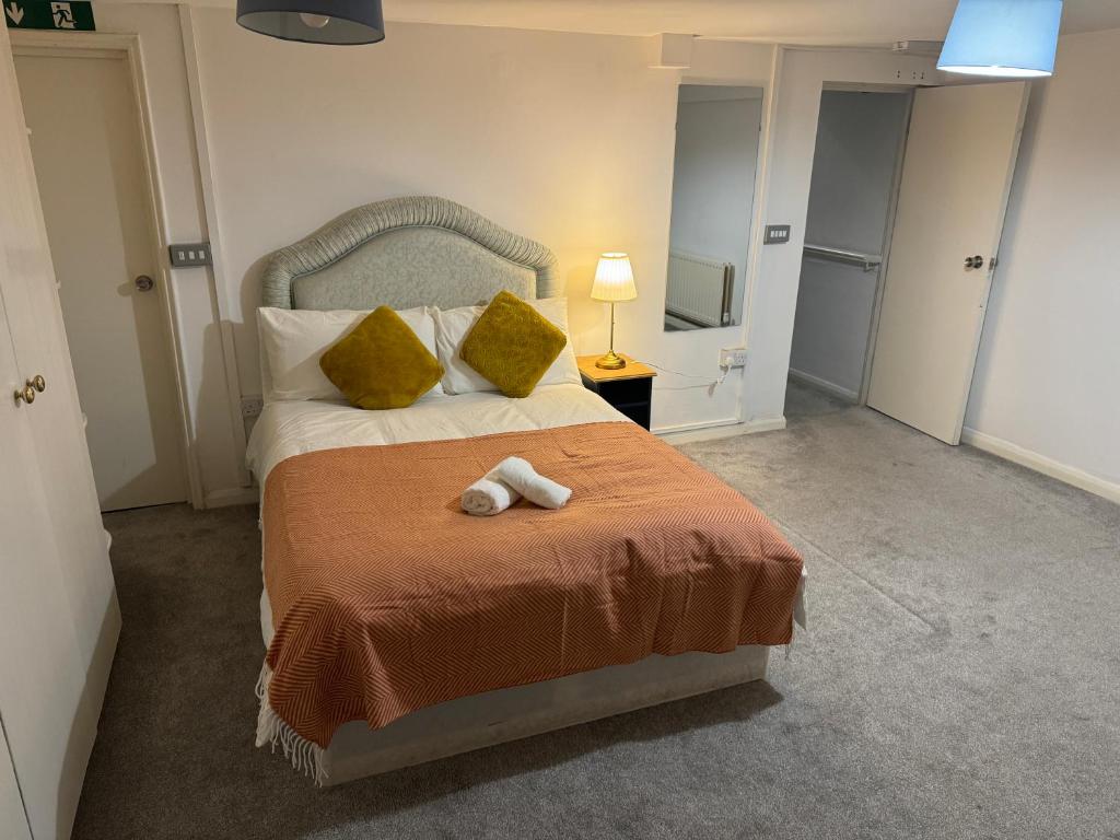a bedroom with a bed with two towels on it at Modern En-Suite Rooms by Finsbury Park Station 8 mins to King's Cross by Tube in London