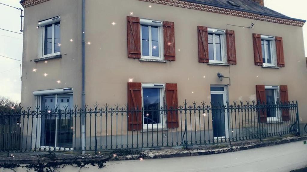 a white house with windows and a fence at Maison de maître in Bressuire