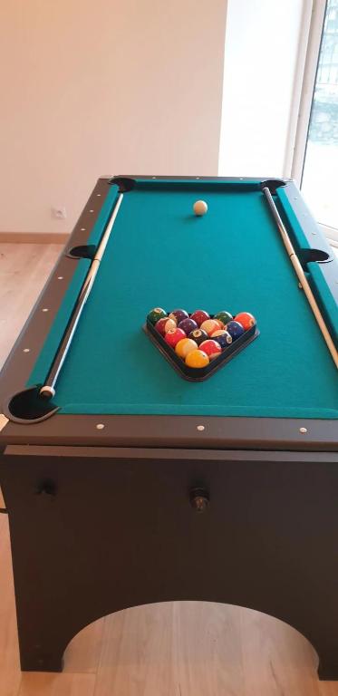a pool table with cue balls on top of it at Maison de maître in Bressuire
