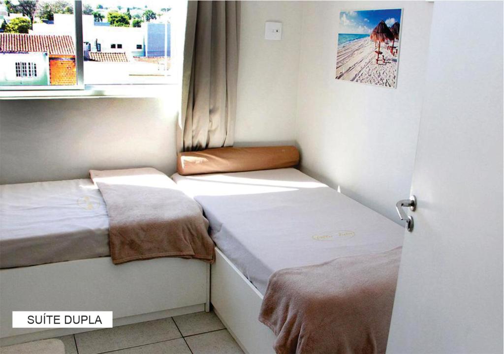 Postel nebo postele na pokoji v ubytování Villa Tata Suítes Ltda