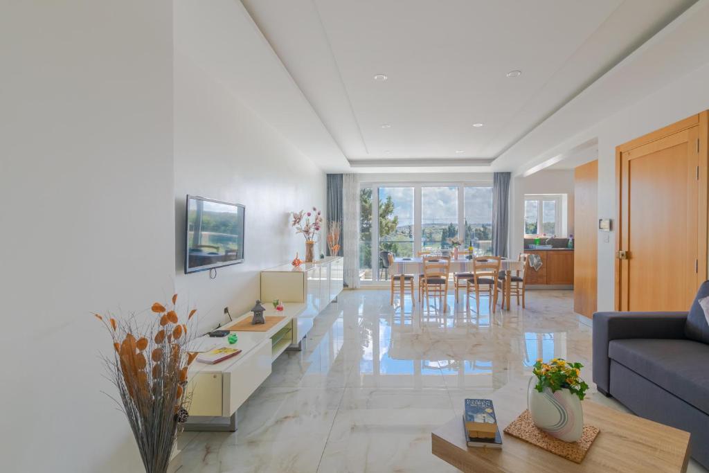 a living room with a couch and a table at New Spacious Apartment 3 Bdr 2 Bth Bugibba S in St Paul's Bay