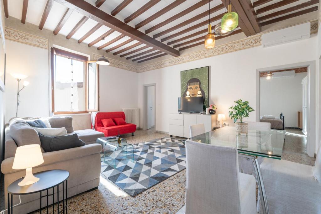 a living room with a couch and a glass table at Urban Center Arezzo in Arezzo