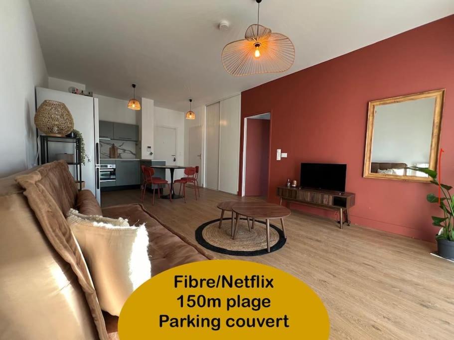 a living room with a couch and a table at Appartement 48 m2 neuf 150m de la mer A307 in Royan