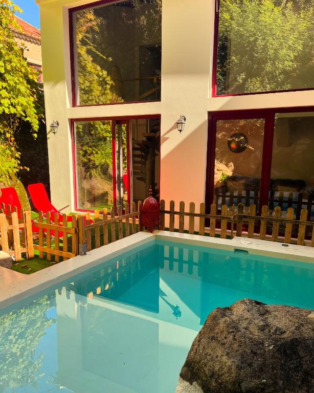 a swimming pool in front of a house at Bloom Cottage I - Sintra montain in Sintra