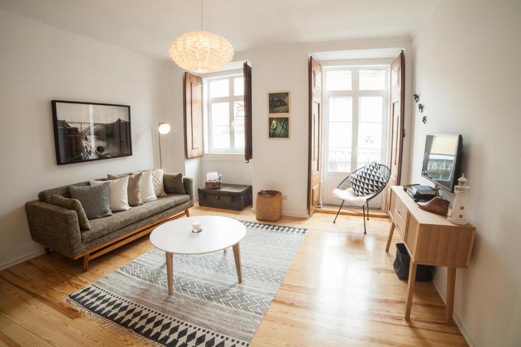a living room with a couch and a table at FLH Estrela Comfortable Flat in Lisbon