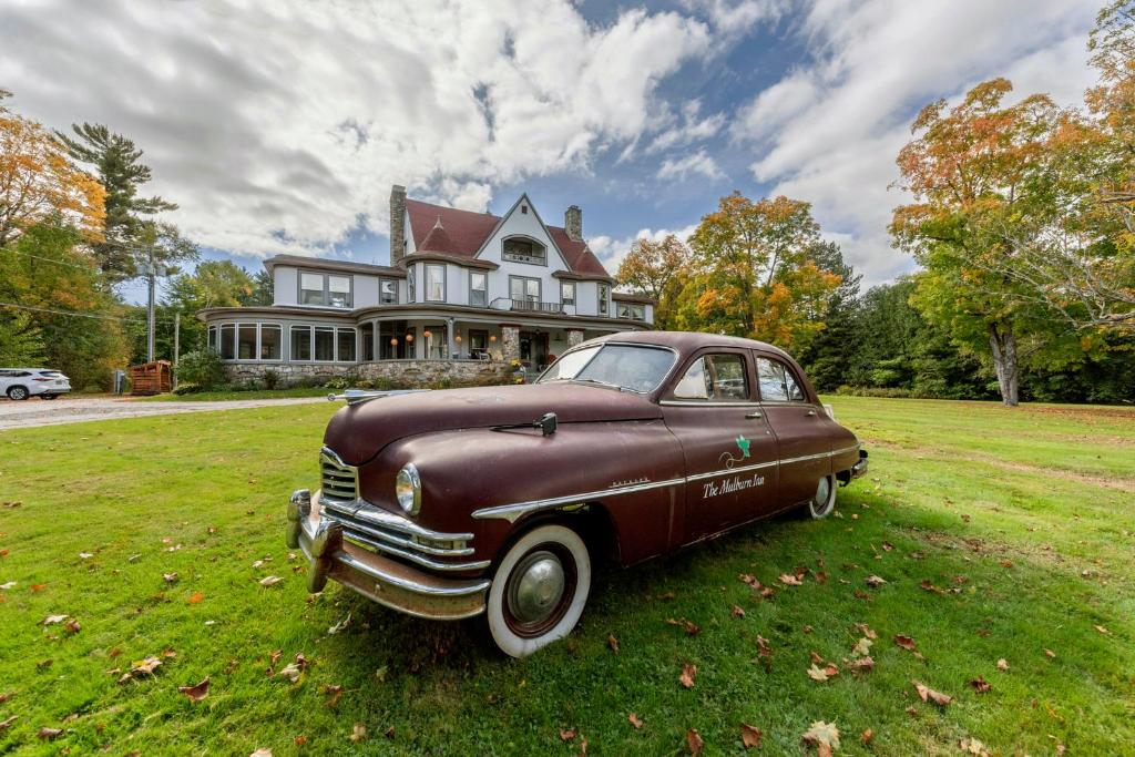 an old car parked in front of a house at The Mulburn Inn in Bethlehem