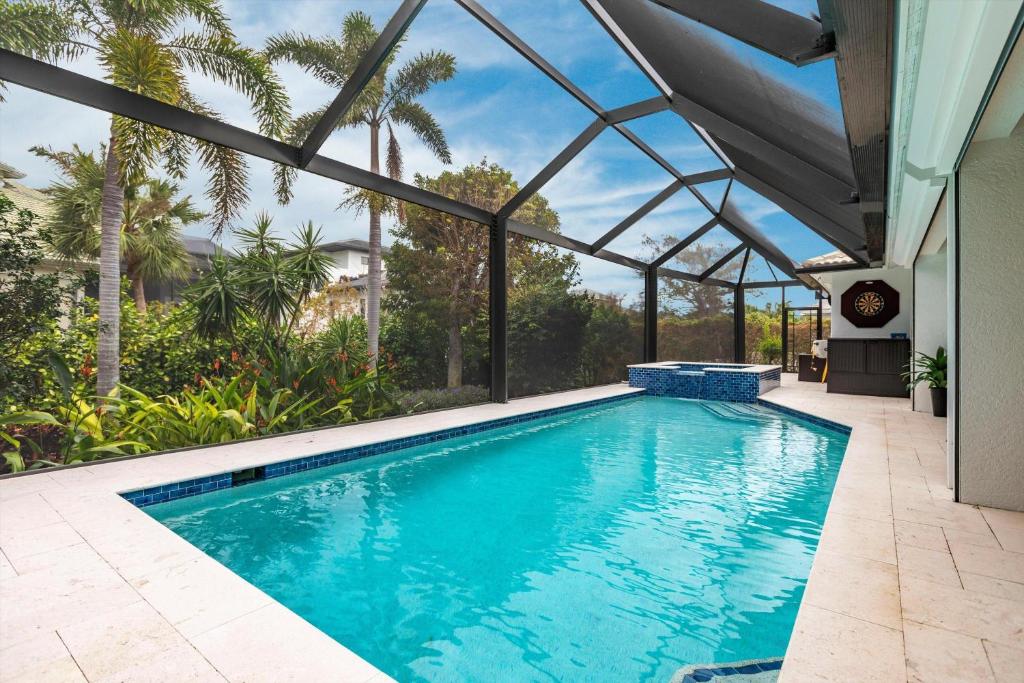 an indoor swimming pool with a glass ceiling at 316 Marco in Marco Island