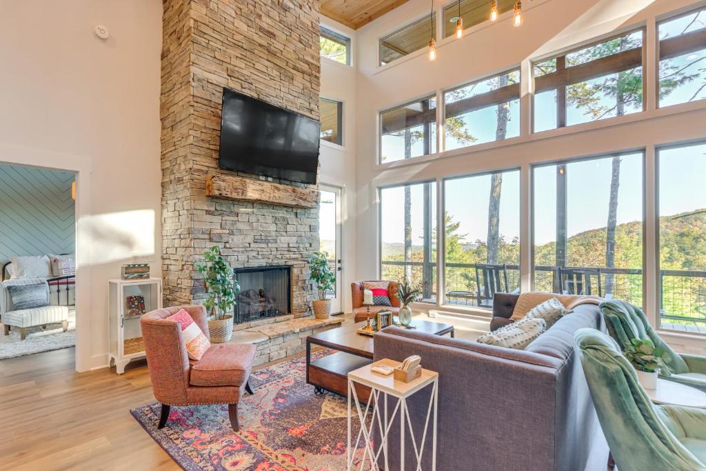 ein Wohnzimmer mit einem Steinkamin und einem TV in der Unterkunft Modern Mtn Cabin with Deck and Views in Blue Ridge! in Blue Ridge