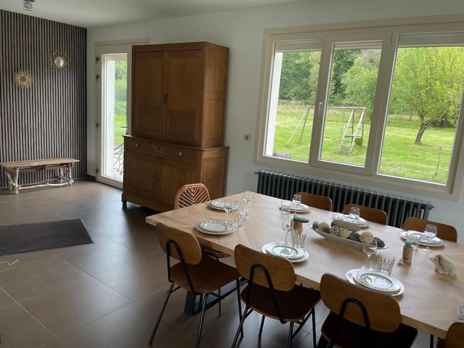 a large dining room with a table and chairs at Gîte le Beauchamp in Les Hautes-Rivières
