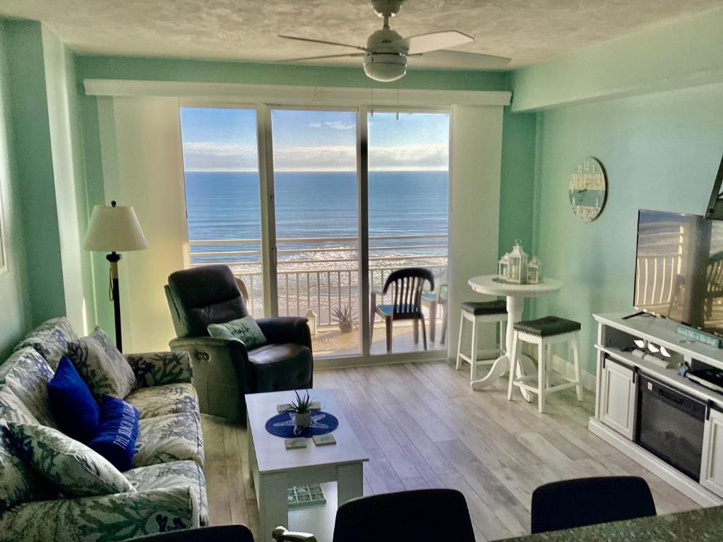 a living room with a view of the ocean at Ocean Walk Resort - Striking Ocean Front View in Daytona Beach
