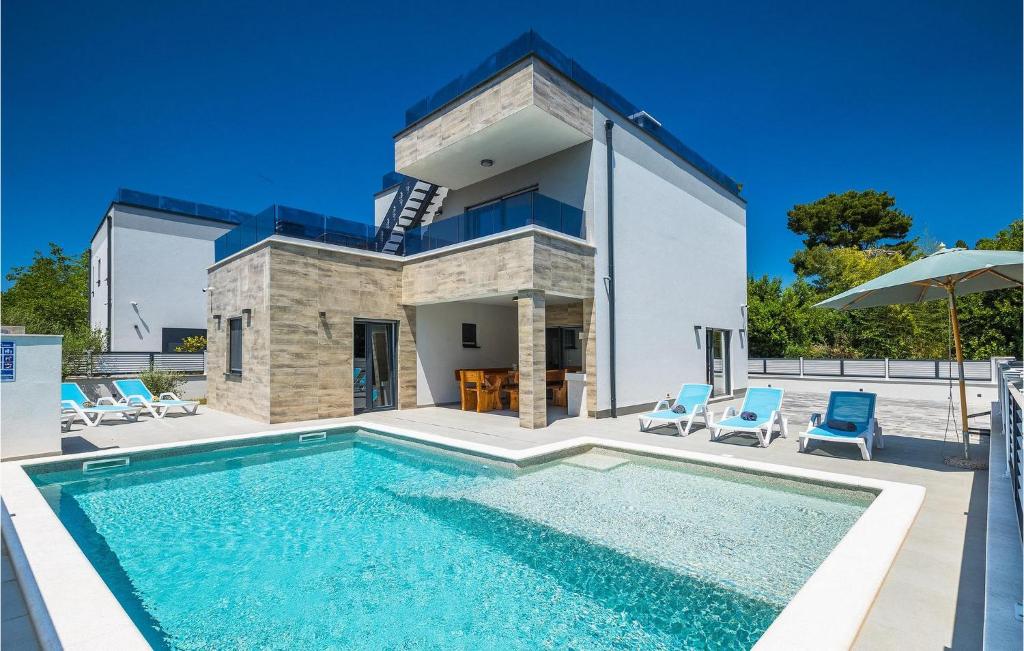 a villa with a swimming pool in front of a house at Villa Pervan in Pula