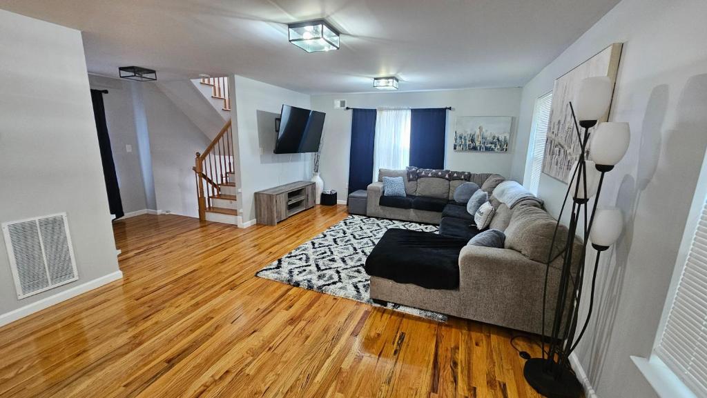 a living room with a couch and a television at NYC & Downtown Newark Commuter Dream Stay in Newark
