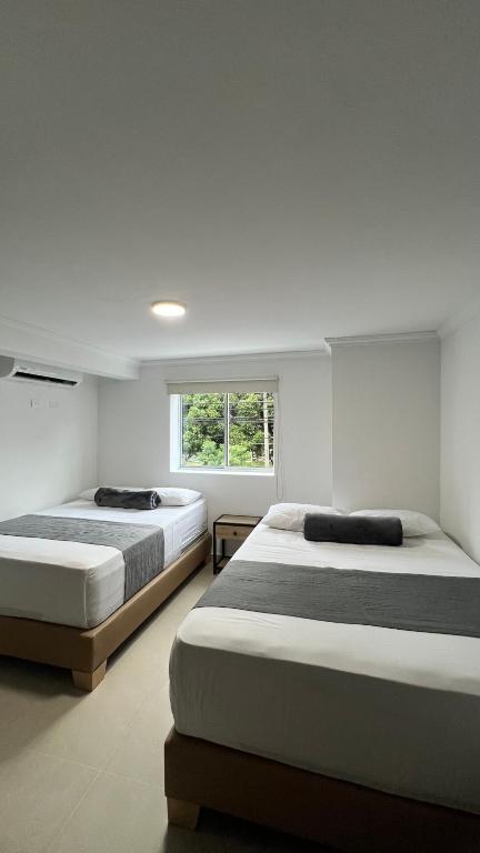 Postel nebo postele na pokoji v ubytování Hotel Medellín 66