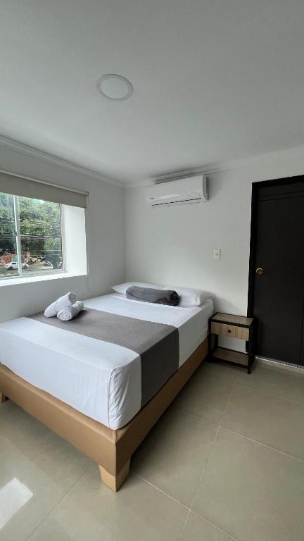 Postel nebo postele na pokoji v ubytování Hotel Medellín 66