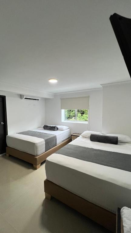 Postel nebo postele na pokoji v ubytování Hotel Medellín 66